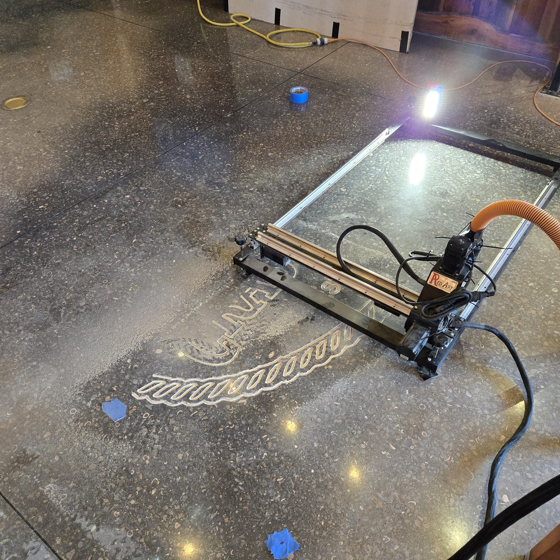 RedArt CNC Pro engraving a logo into a polished concrete floor