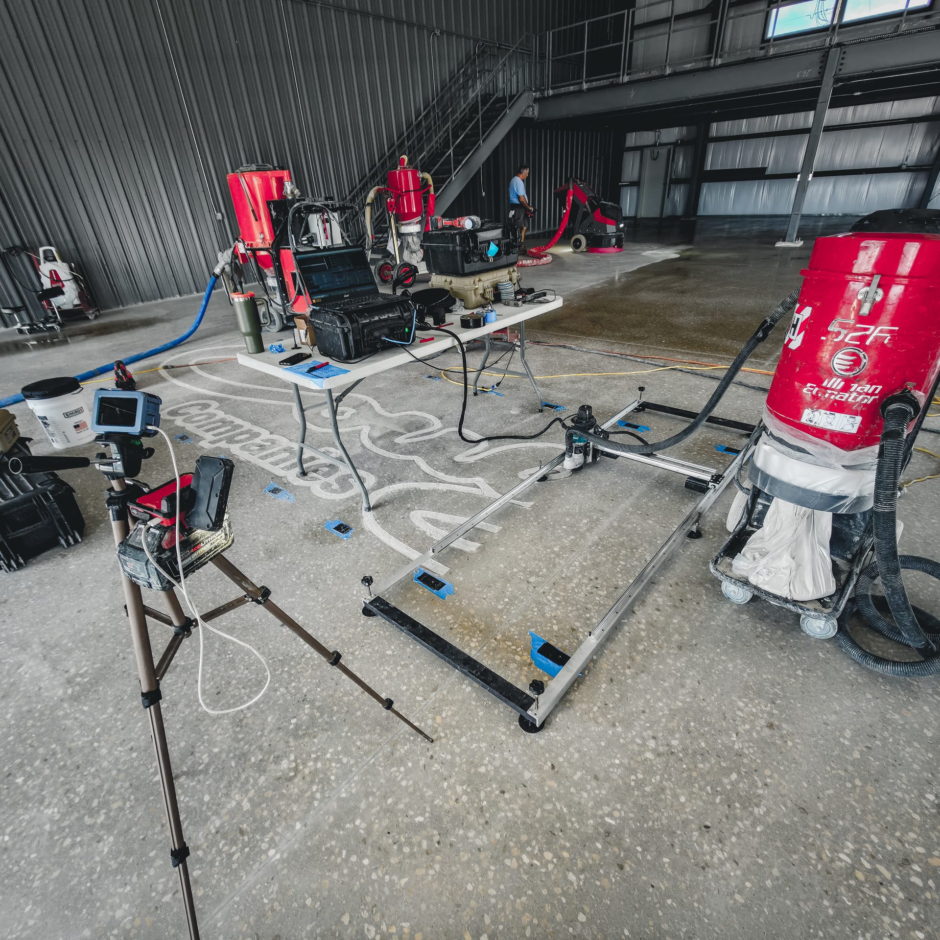 RedArt CNC machine engraving the Cougar Companies logo into the concrete floor