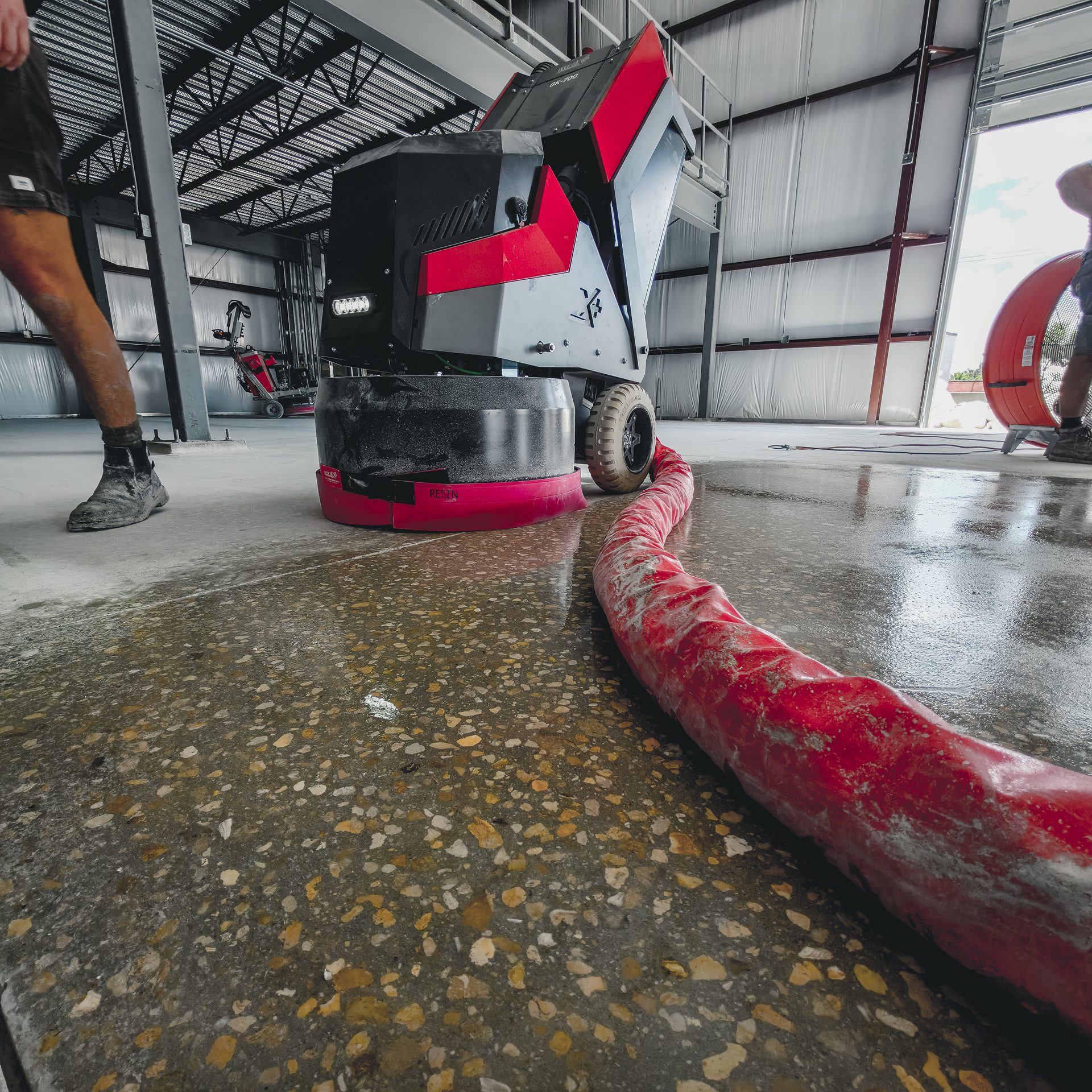 Full aggregate exposed on the Cougar Companies warehouse slab during grinding