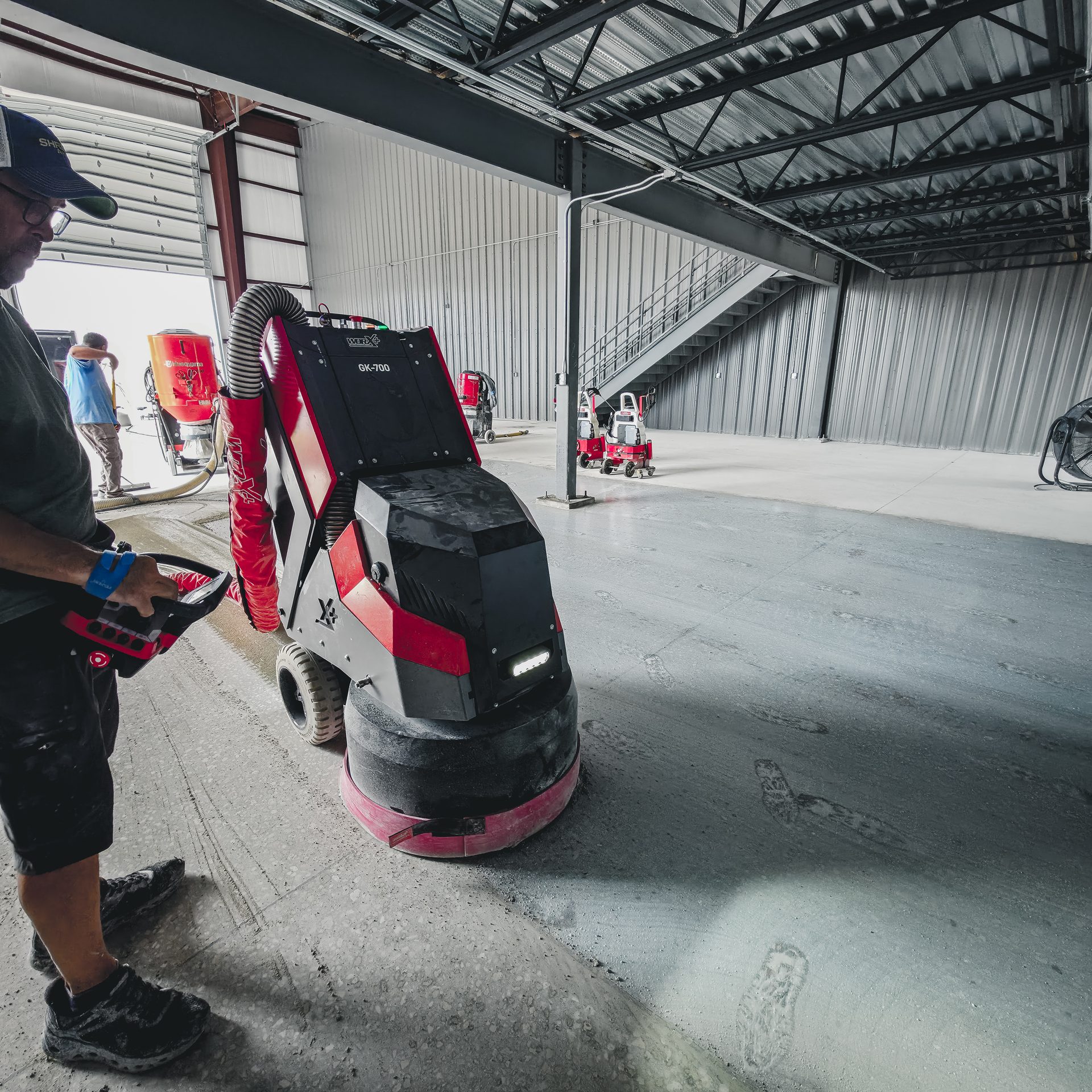 Surface Masters operator running the WORX+ GK700 grinder by remote control