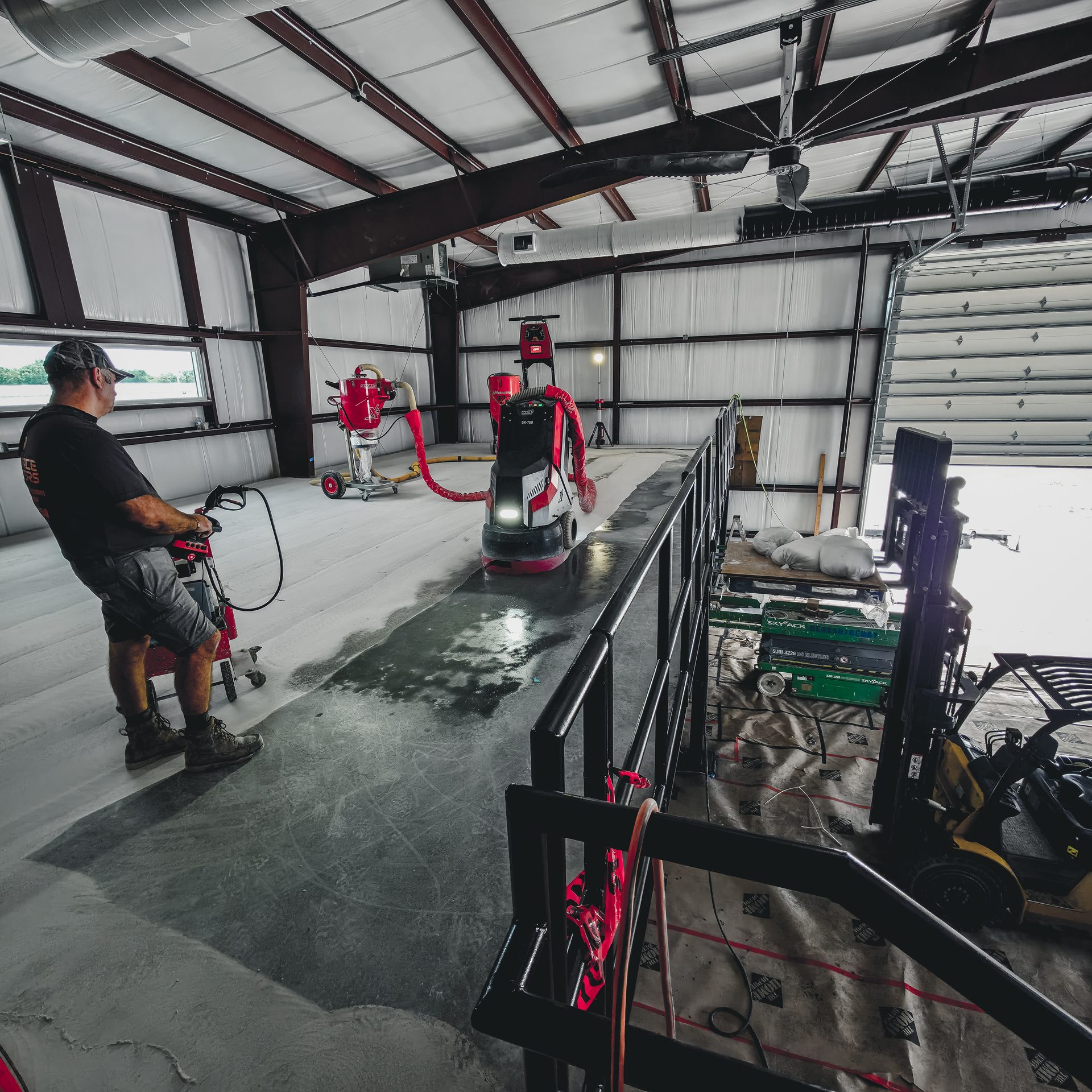Surface Masters grinding the mezzanine while a forklift works the first floor below