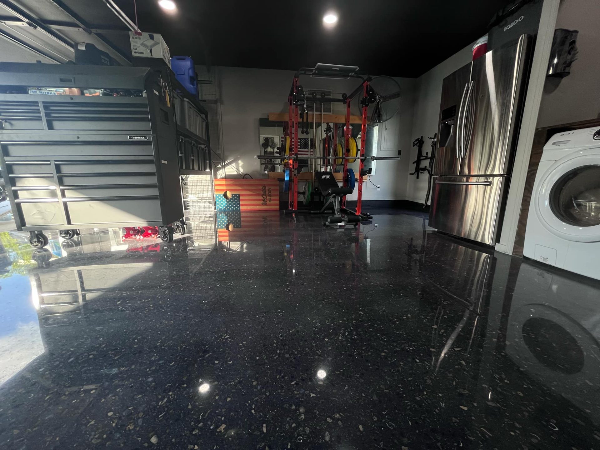 Black polished residential garage with gym