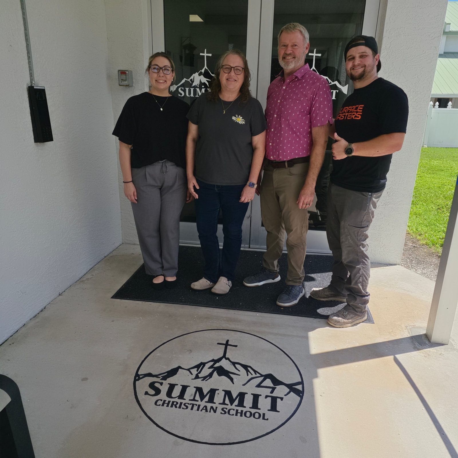 Summit Christian School staff and Surface Masters standing behind the CNC engraved school logo